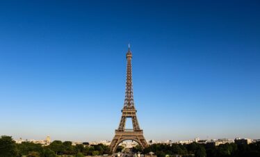 Stunning daylight shot capturing the Eiffel Tower with clear blue skies in Paris.